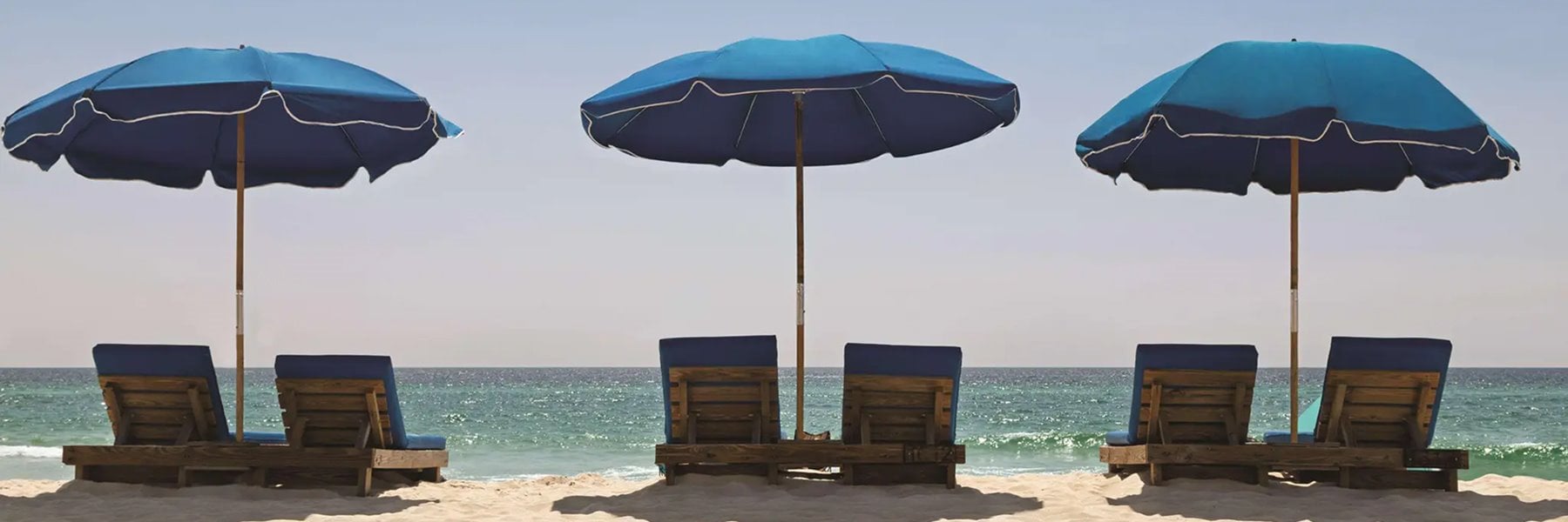 Beach setup with blue umbrellas at Radisson Beachfront Hotel - Panama City Beach-Florida